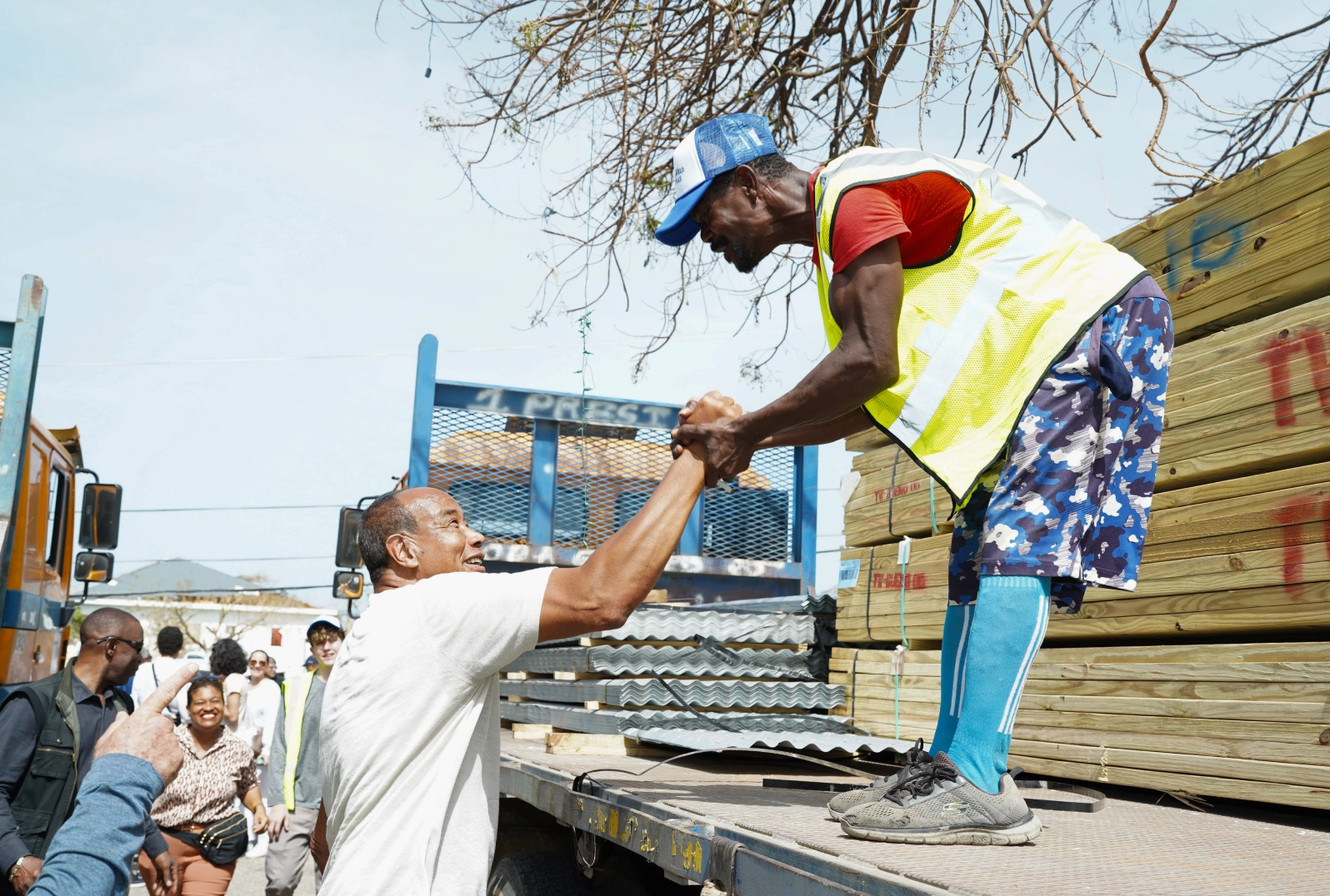 Michael Lee-Chin greets man on truck